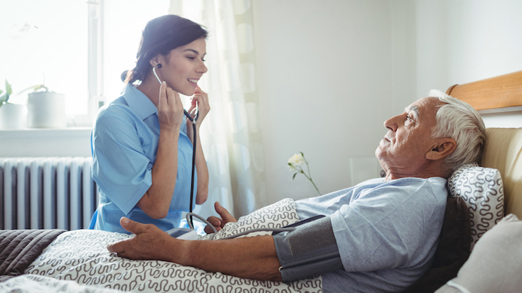 nurse using stethoscope on resident