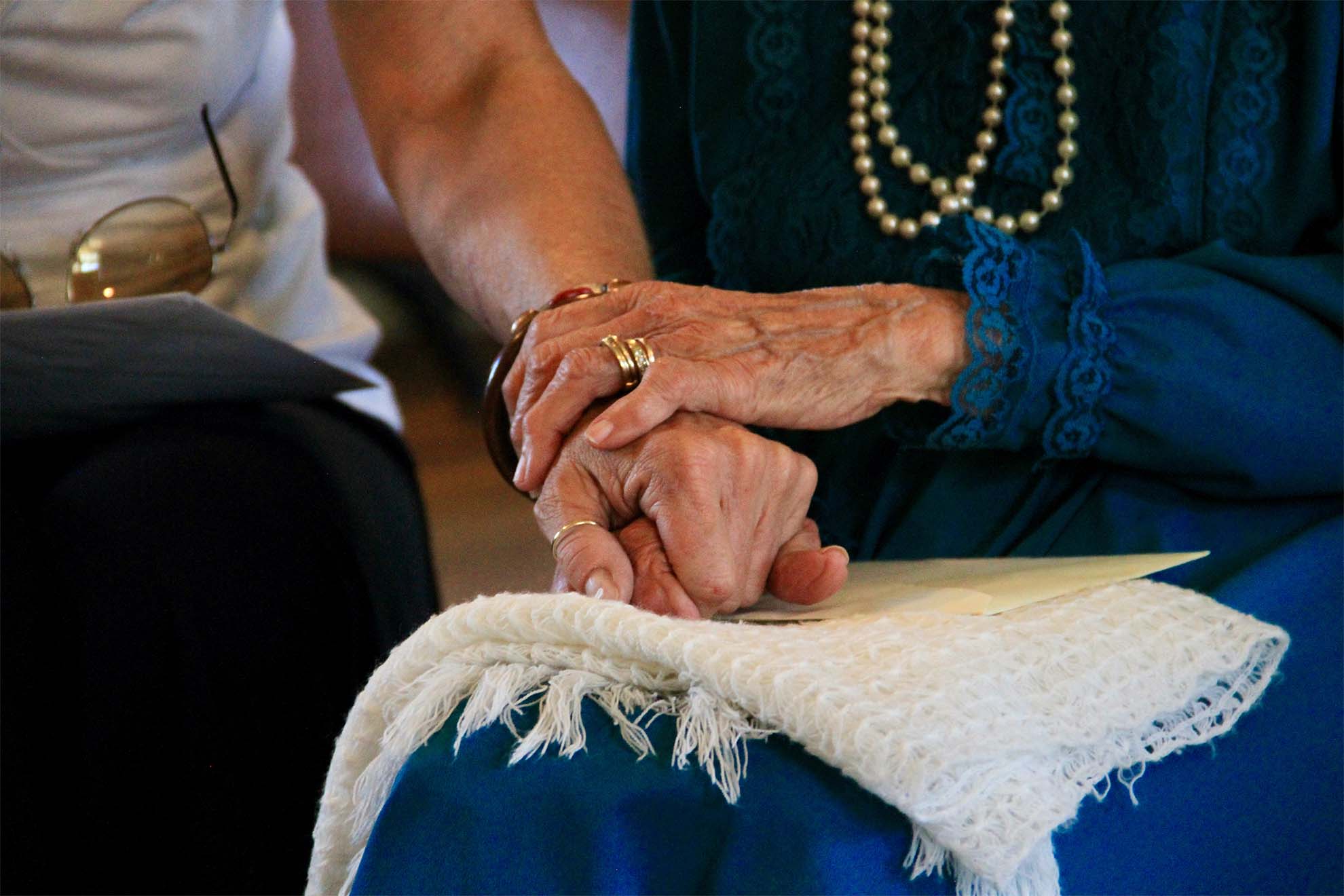 resident holding hand of loved one