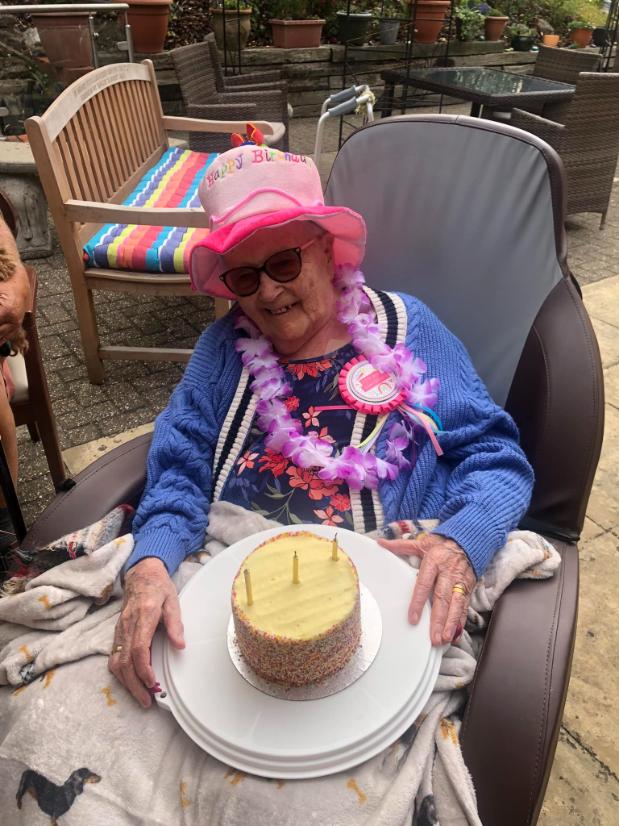 resident with a birthday cake