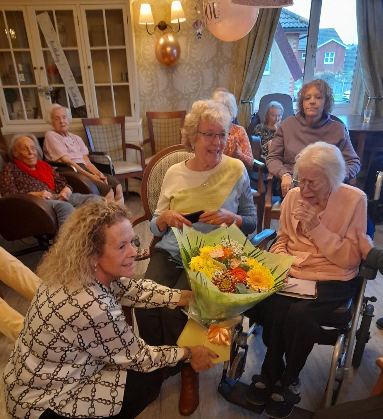 resident getting given flowers