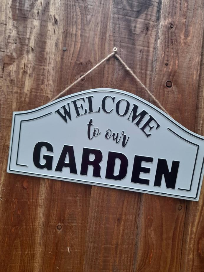 sign that says welcome to our garden