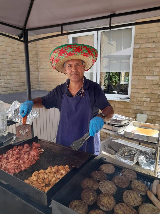 a man in a sombrero operating a bbq