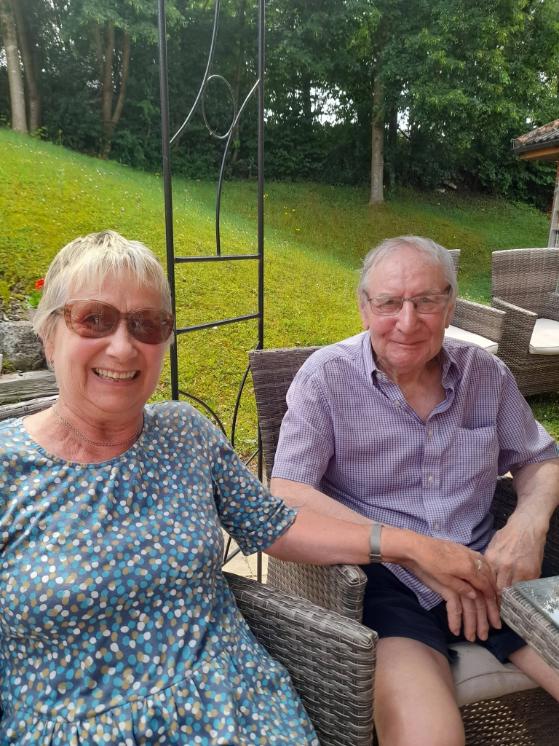 an older couple sat in a garden