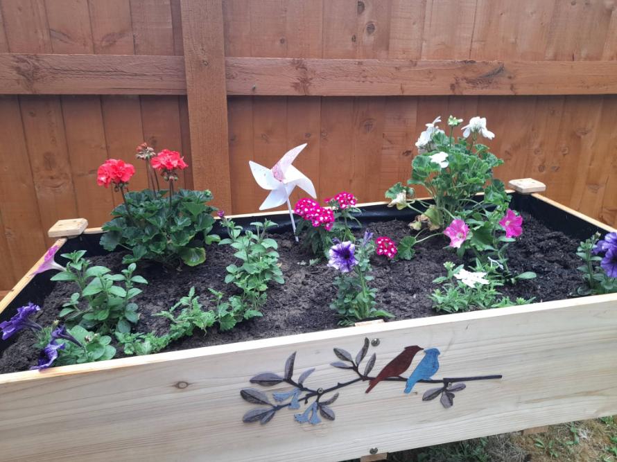 a raised planter with flowers in it