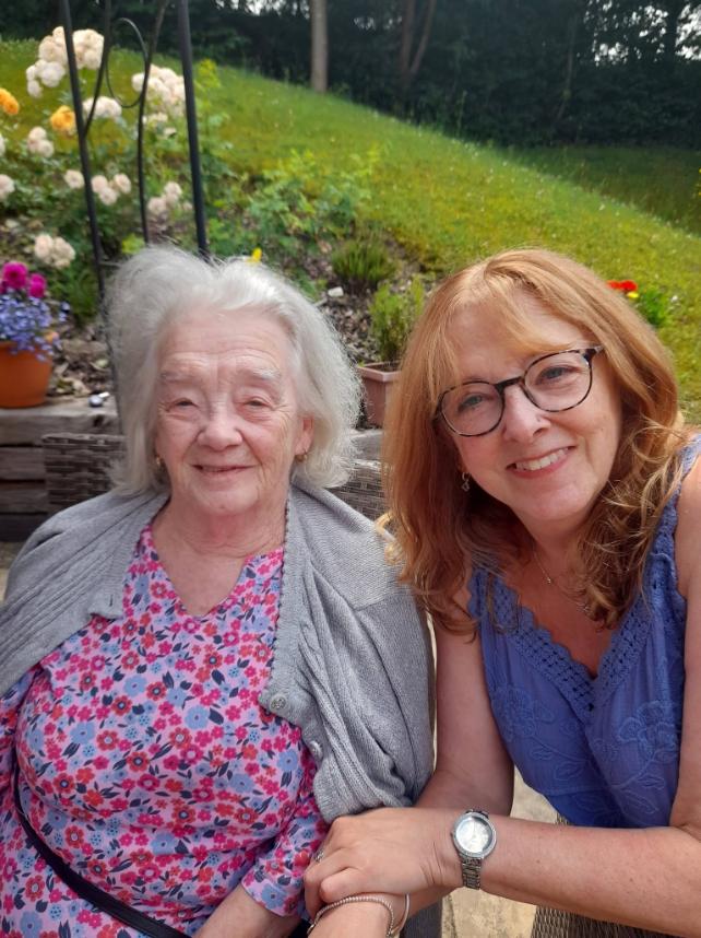 two ladies sat outside in the garden